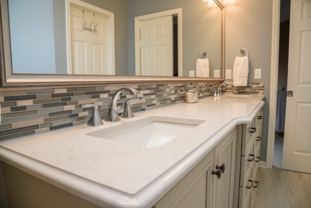 A bathroom with a double sink and a large mirror.