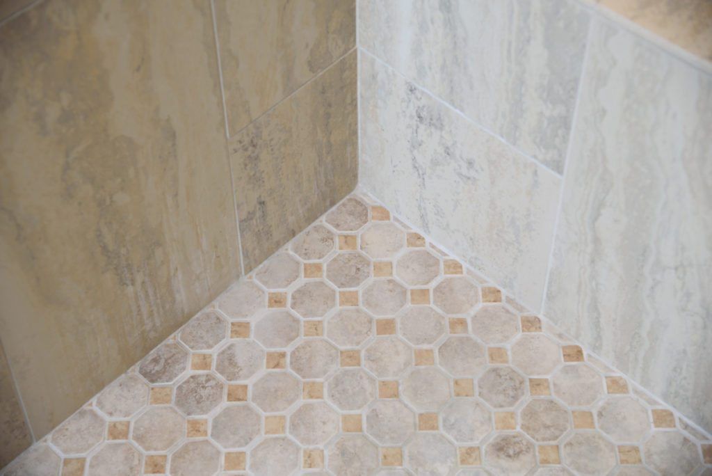 A close up of a tiled floor in a shower.