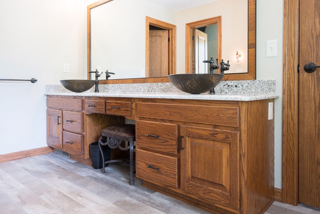 A bathroom with two sinks and a large mirror.