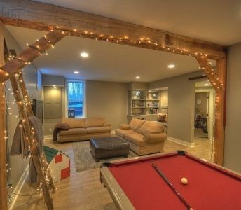 A living room with a pool table and a couch