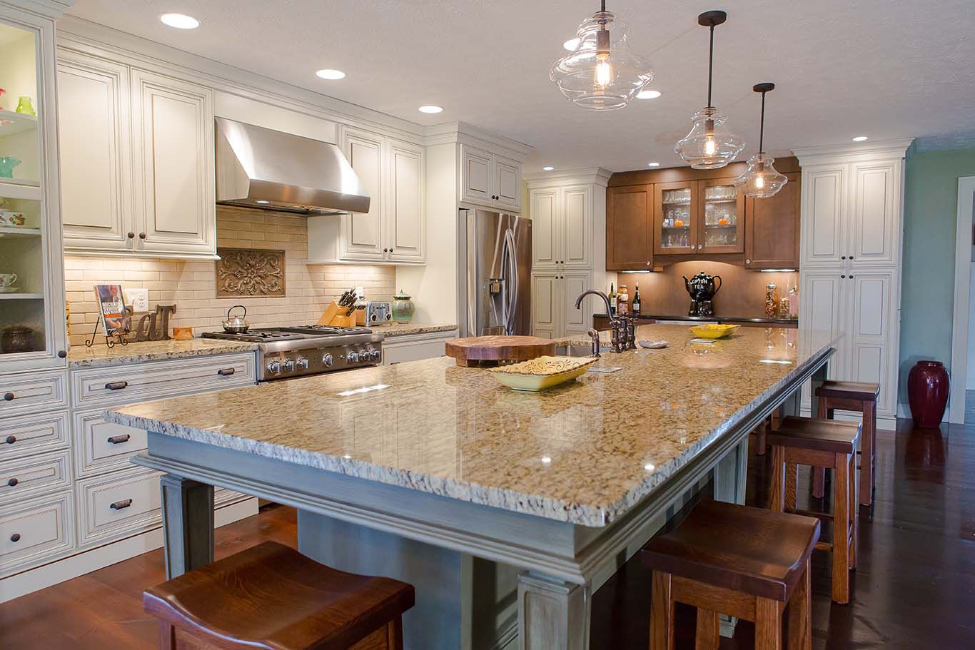 A kitchen with a large island and stools