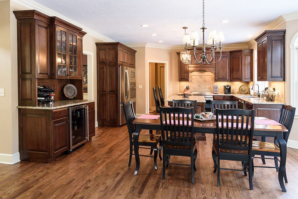 A kitchen with a table and chairs in it