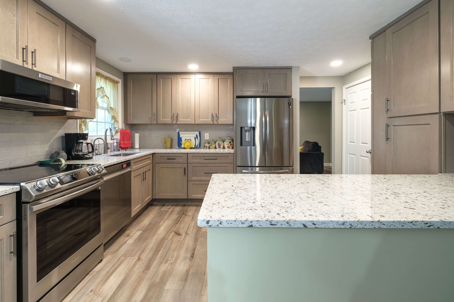 A kitchen with stainless steel appliances and granite counter tops.