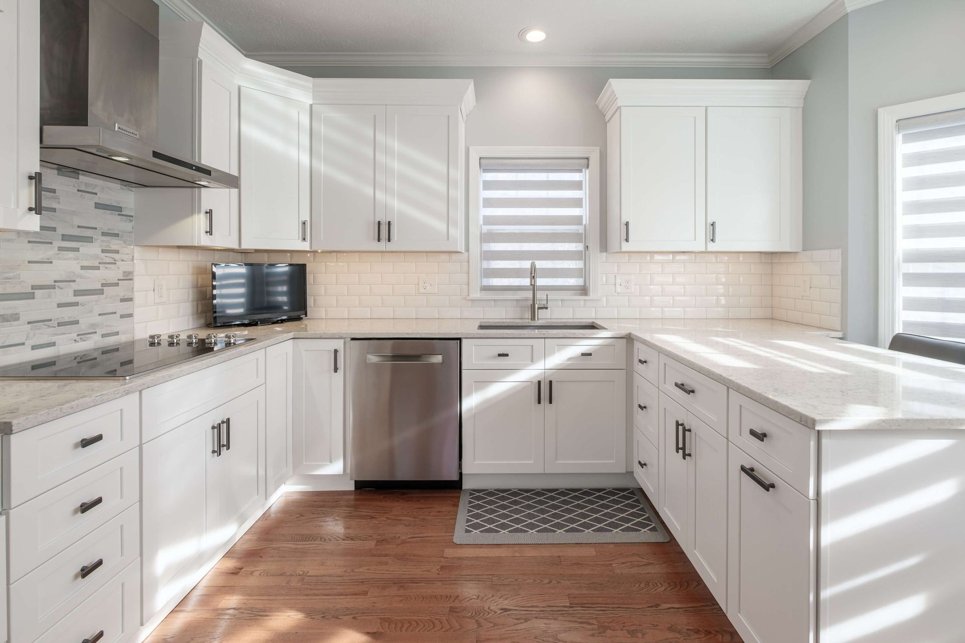 A kitchen with white cabinets and stainless steel appliances.