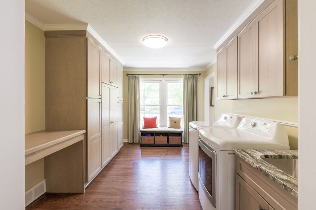 A laundry room with a washer and dryer and a sink.