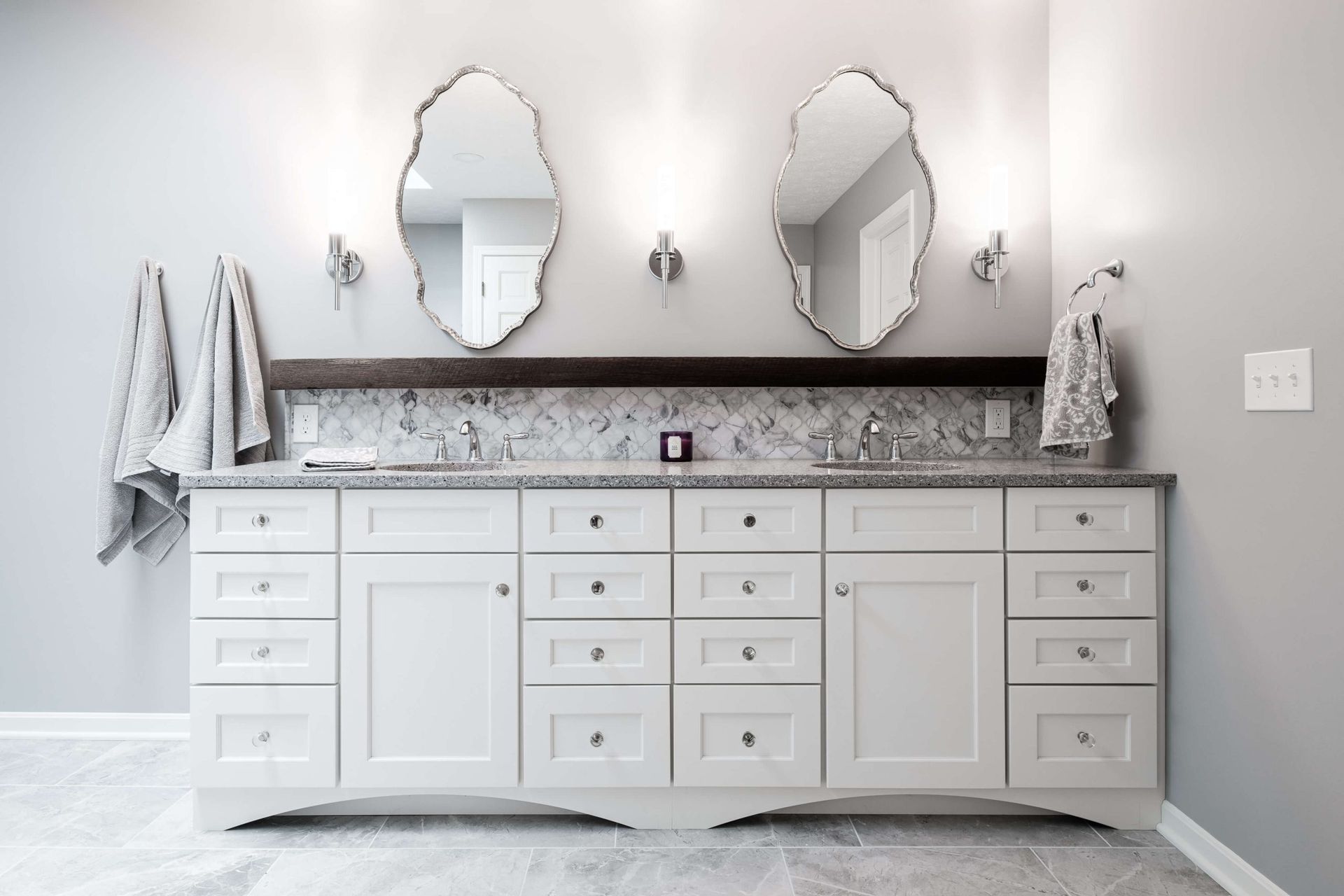A bathroom with two sinks and two mirrors.