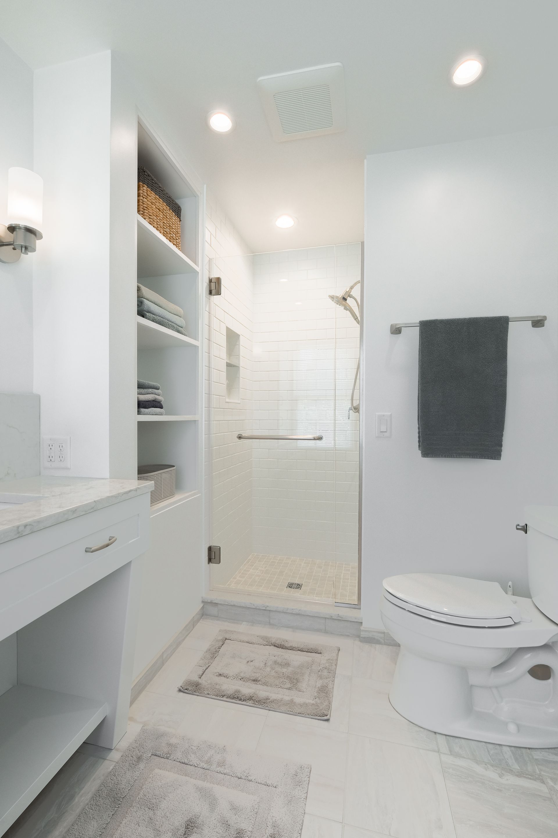 A bathroom with a toilet , sink , and shower.