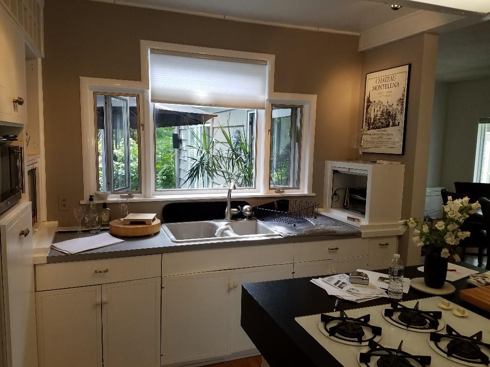 A kitchen with a sink stove and a window