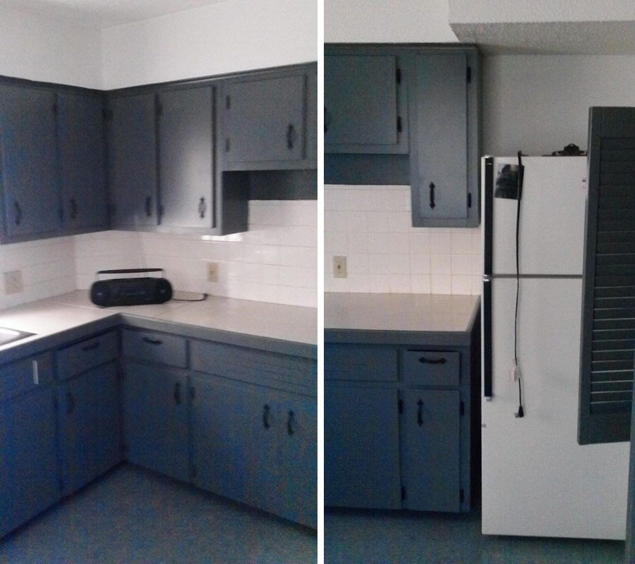A kitchen with blue cabinets and a white refrigerator