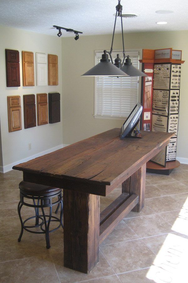 A wooden table with a computer on it in a room