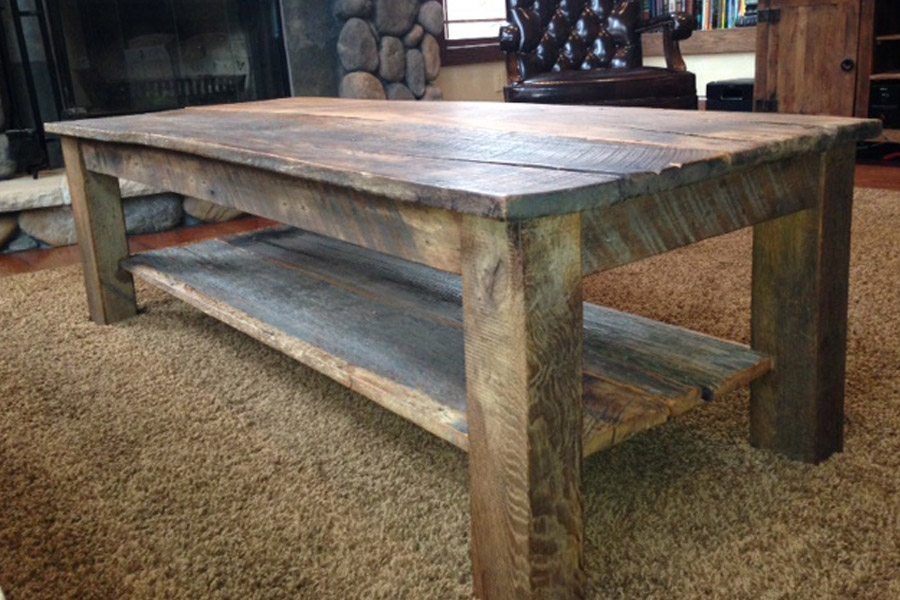 A wooden coffee table with a shelf underneath it in a living room.