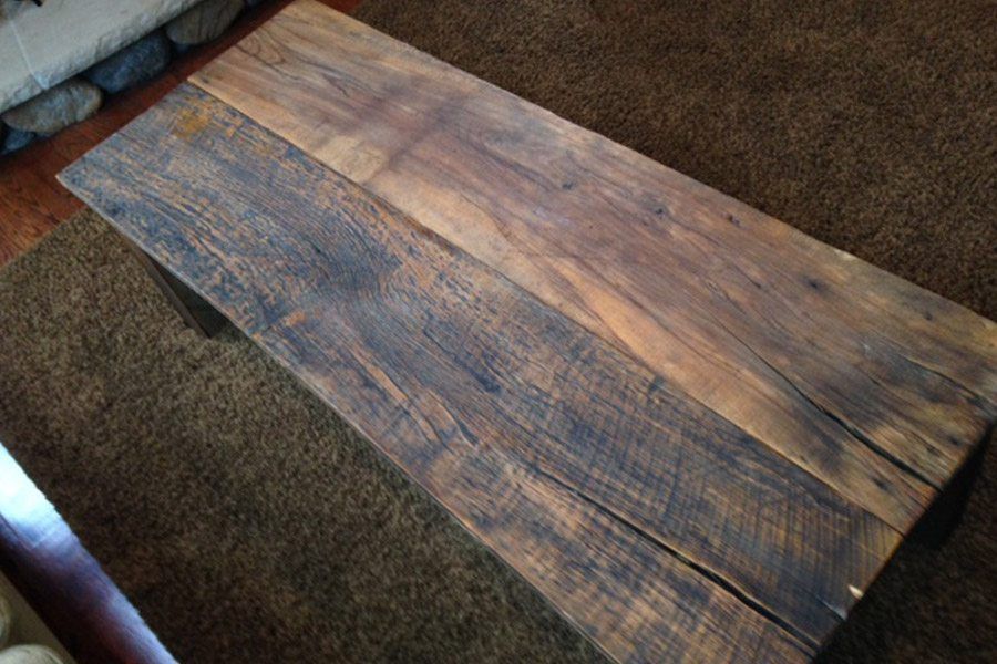 A wooden table is sitting on a rug in a living room.