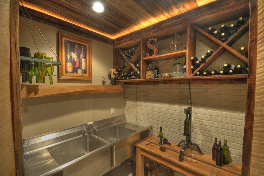 There are many bottles of wine on the shelves in the wine cellar.