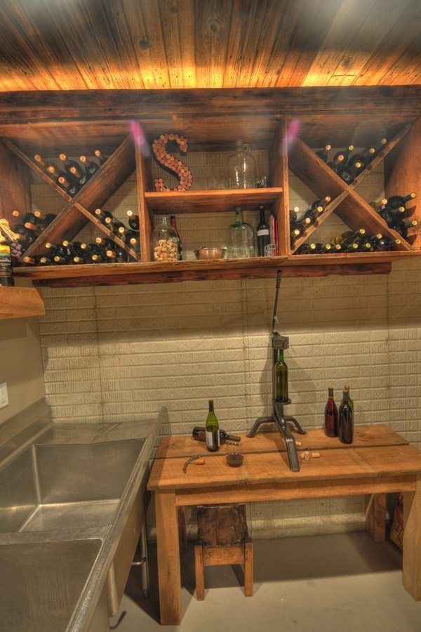 A wine cellar with a table and bottles of wine on it