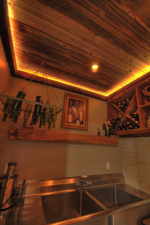 A kitchen with two sinks and a wooden ceiling.