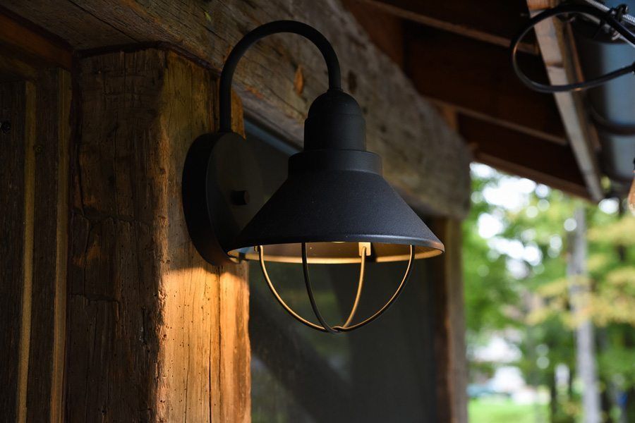 A black light is hanging on a wooden wall.