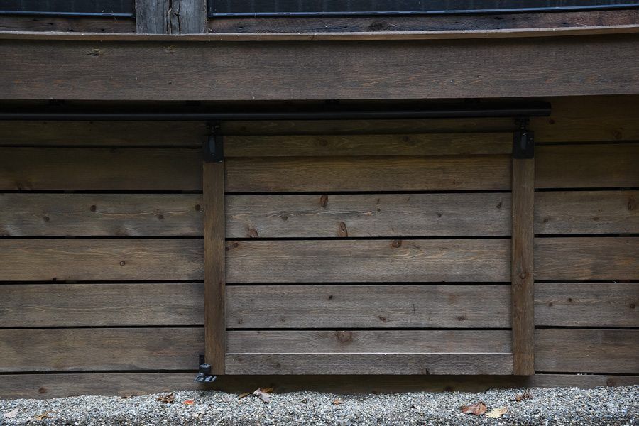 A wooden wall with a window in the middle of it.