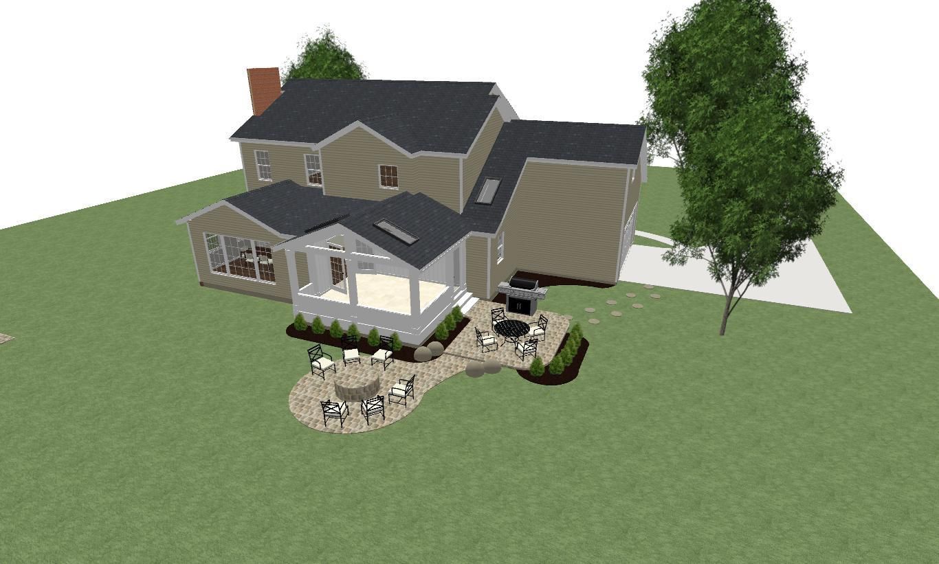 An aerial view of a house with a patio and trees