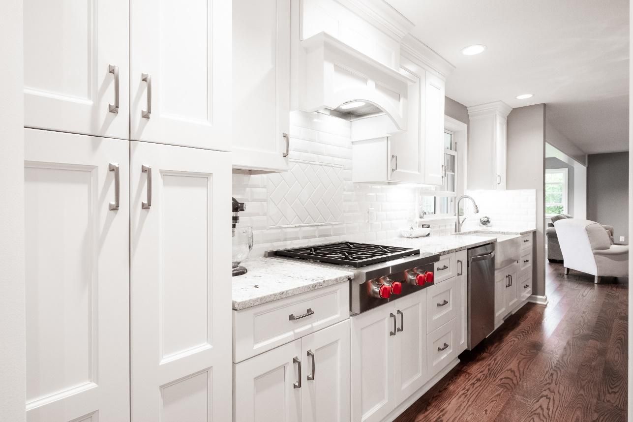 A kitchen with white cabinets and stainless steel appliances.