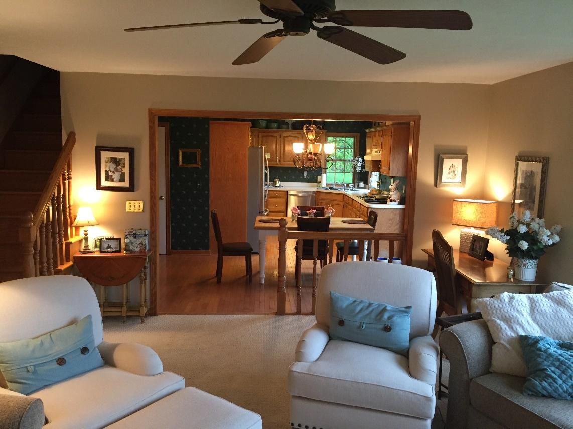 A living room with furniture and a ceiling fan