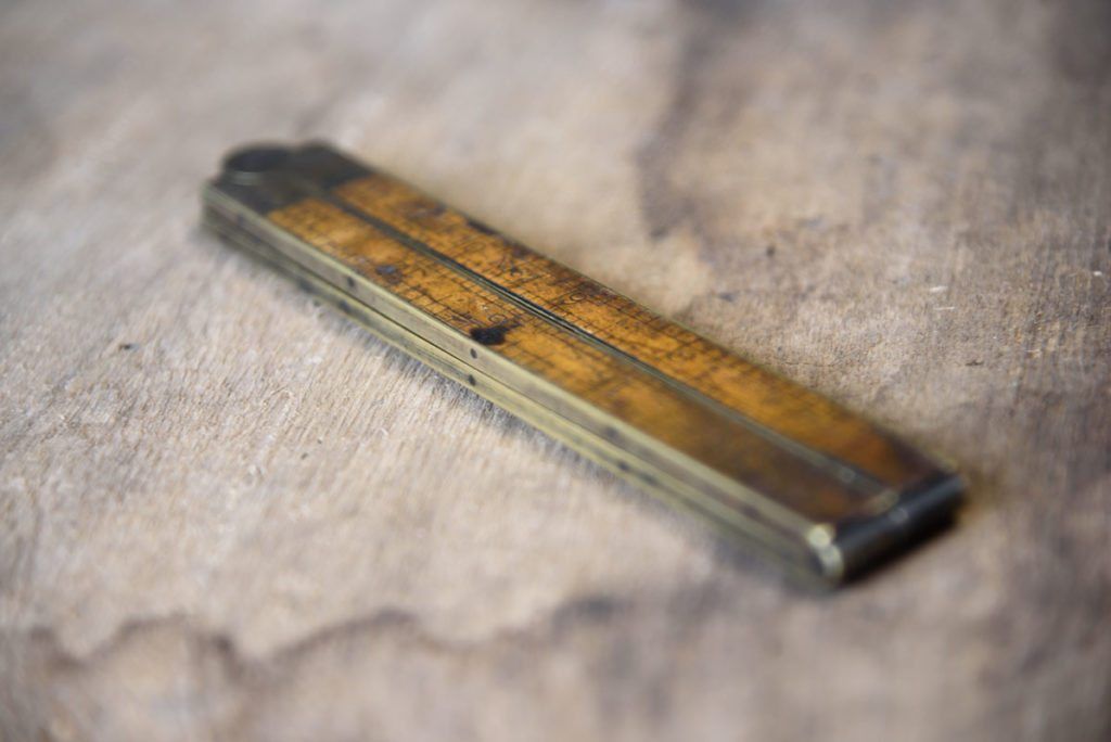 A close up of a wooden ruler on a table.