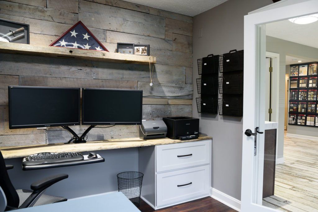 A home office with two computer monitors on a desk.