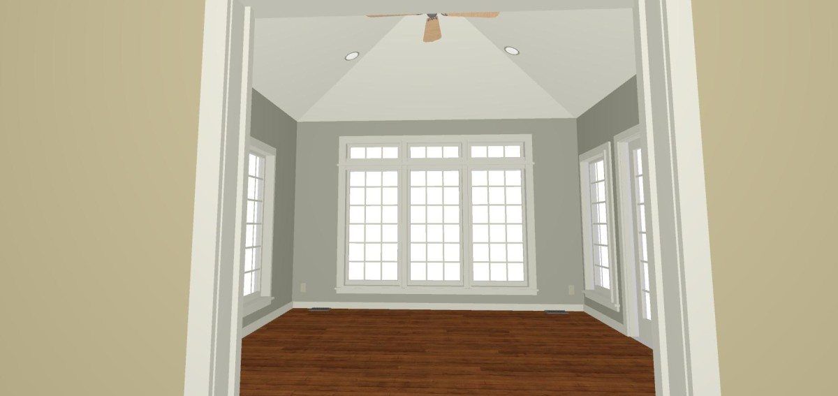 An empty room with a lot of windows and a ceiling fan.