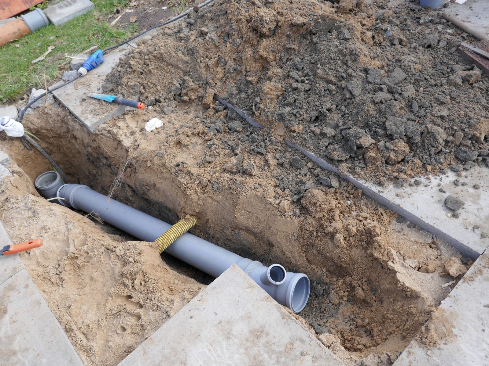 A pipe is being installed in a hole in the ground.