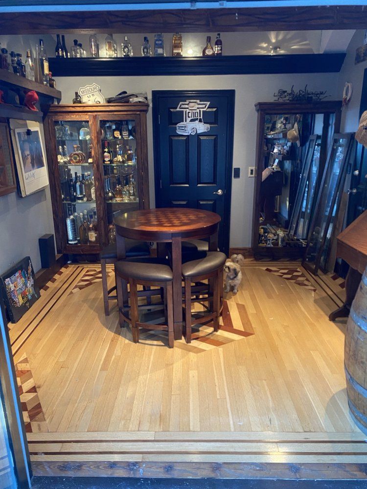 There is a table and chairs in the middle of the room.