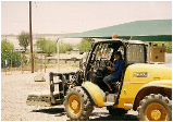 Material Delivery — Driver in Yellow Tractor in Tolleson, AZ