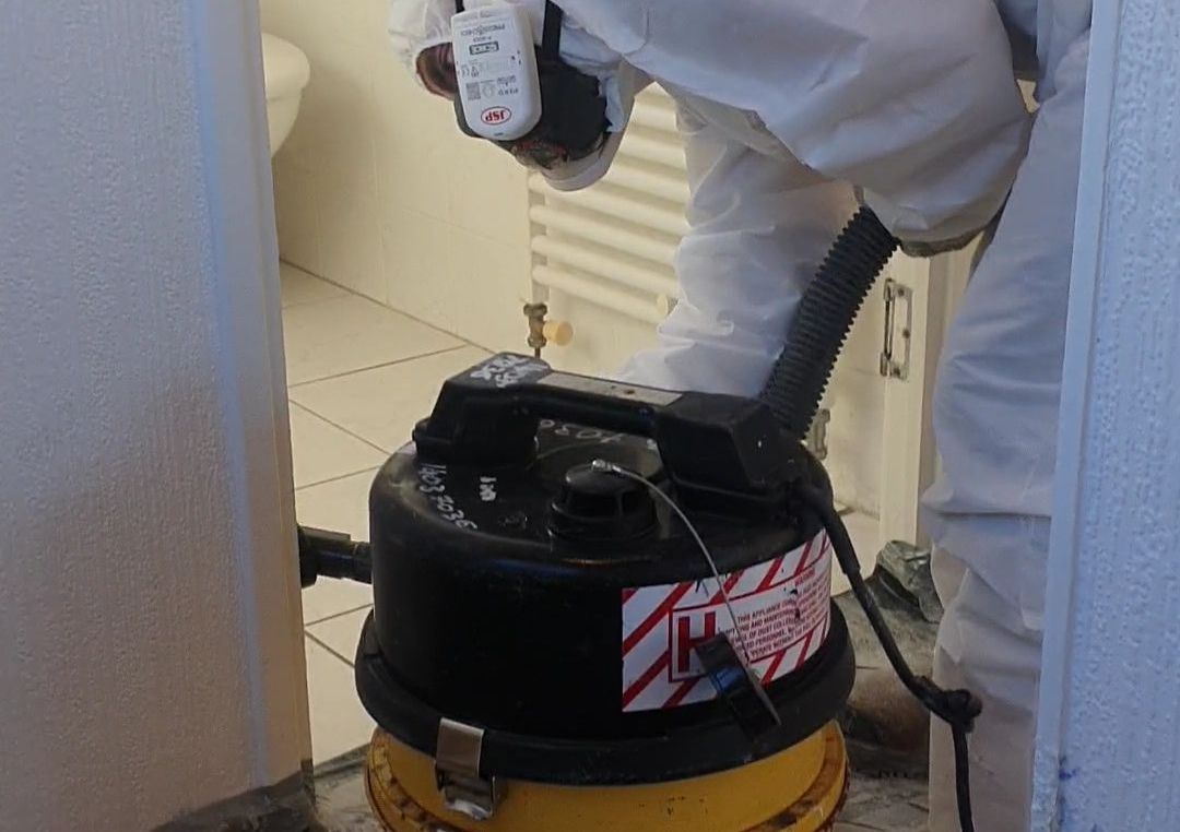 a person is using a vacuum cleaner in a bathroom