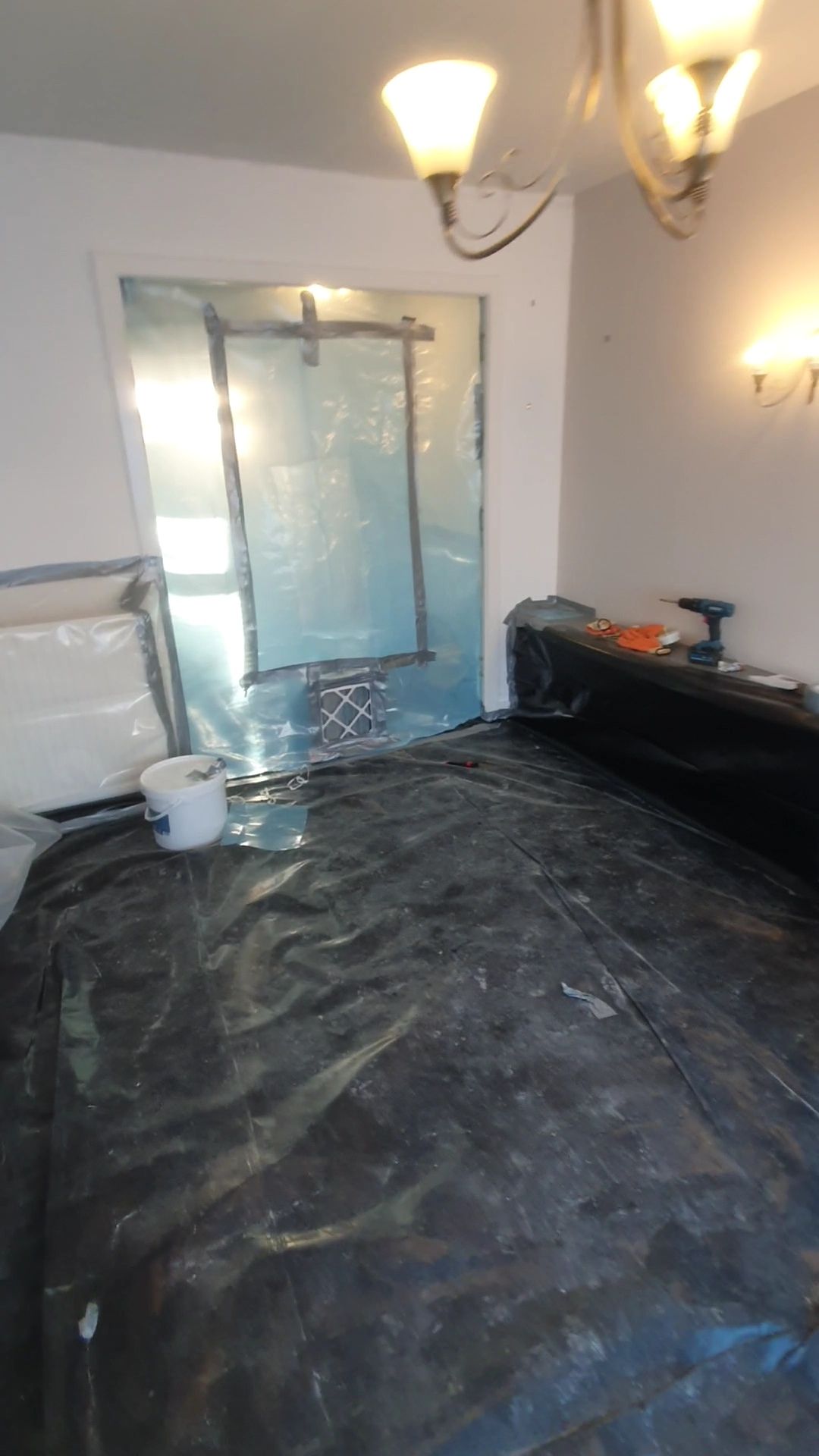 a room with a black tarp on the floor