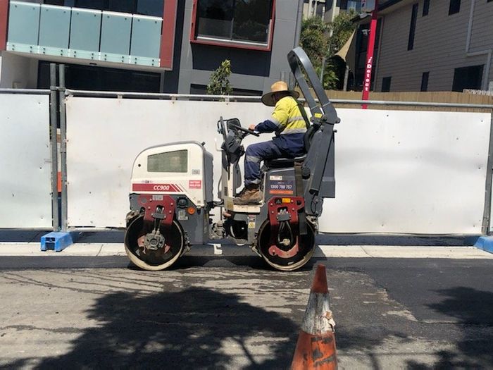 Worker using a Road Roller Machine — Brisbane, QLD — Ashpatch