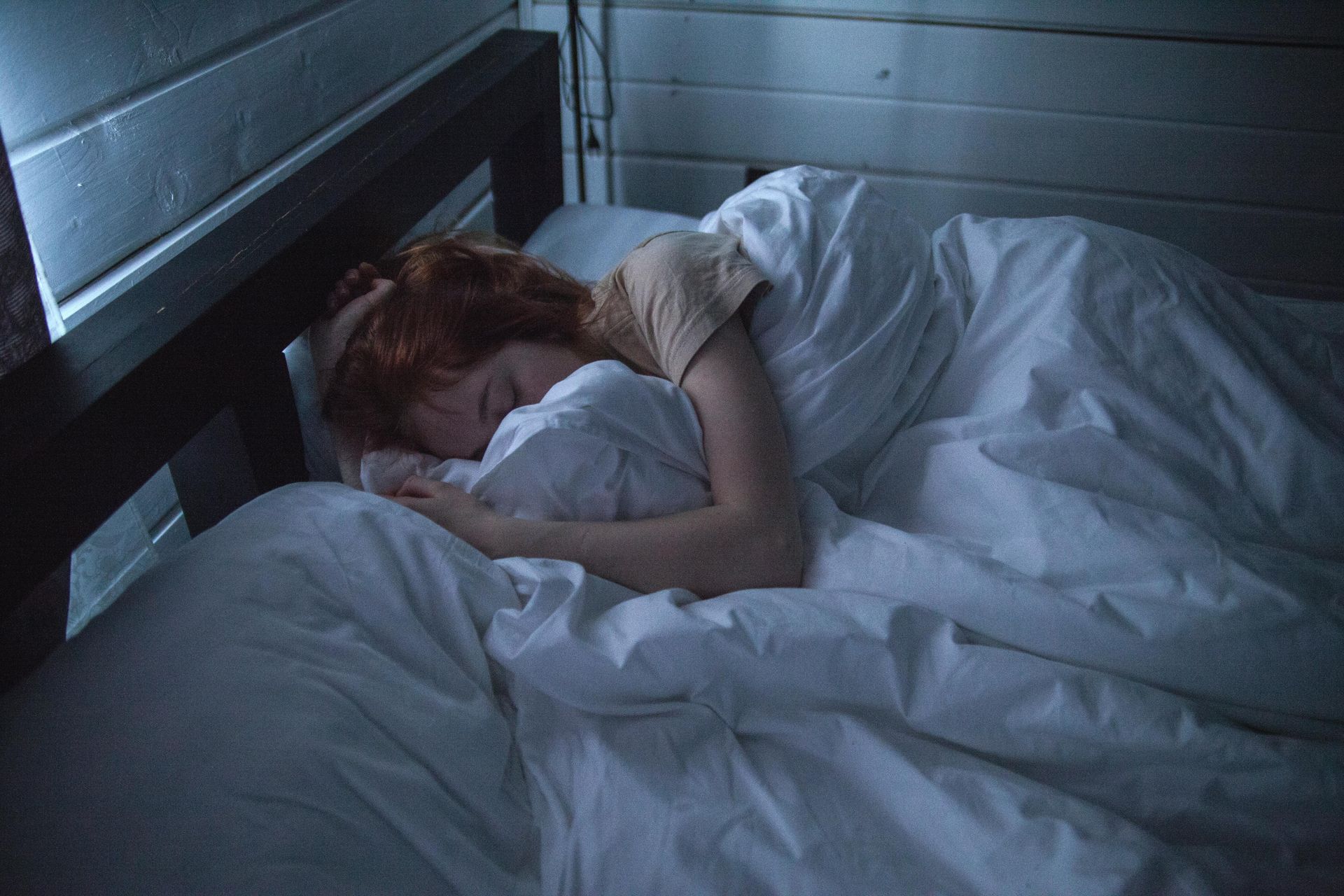 Woman in bed, struggling to sleep