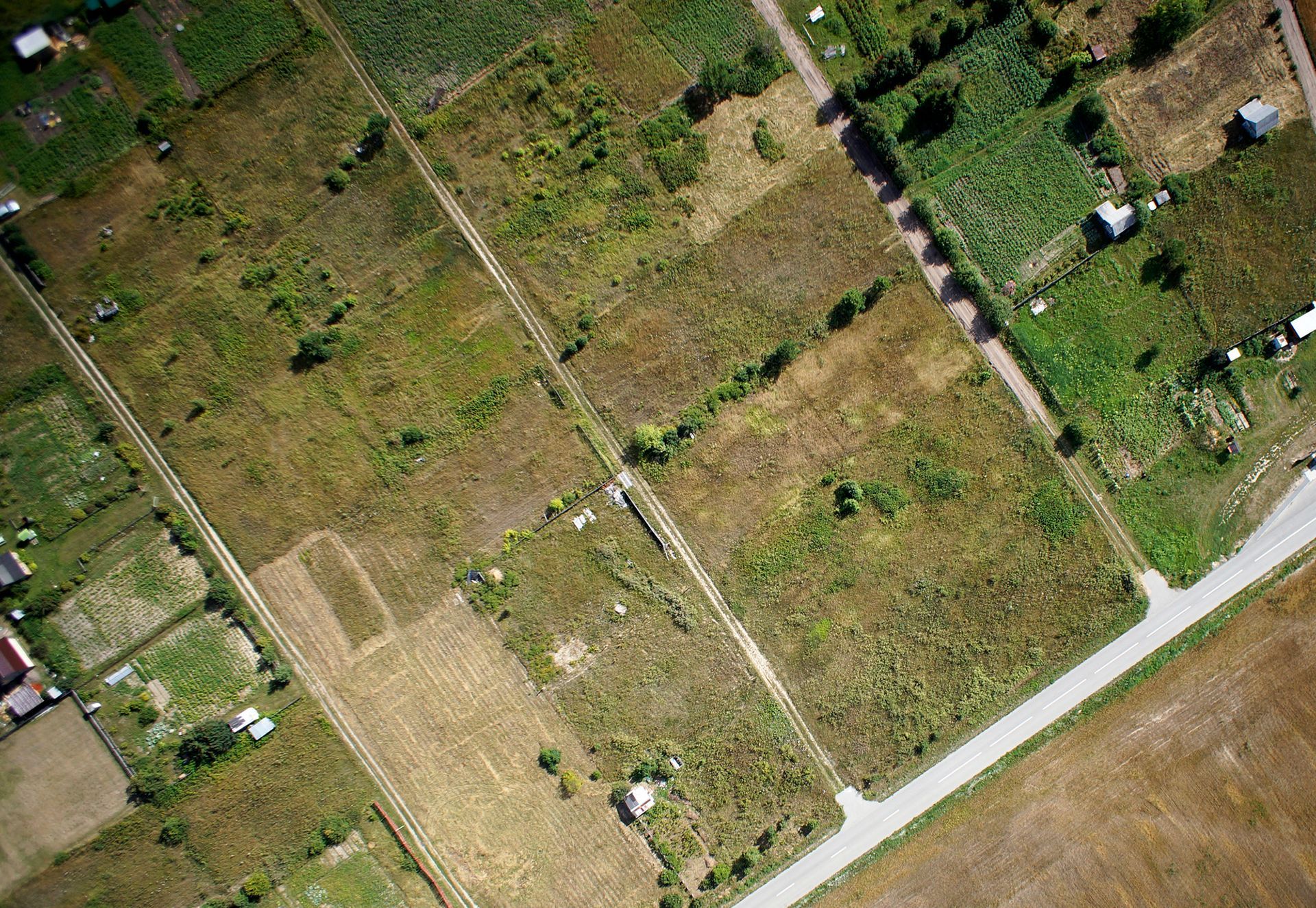 An aerial view of a residential area with lots of fields and roads.