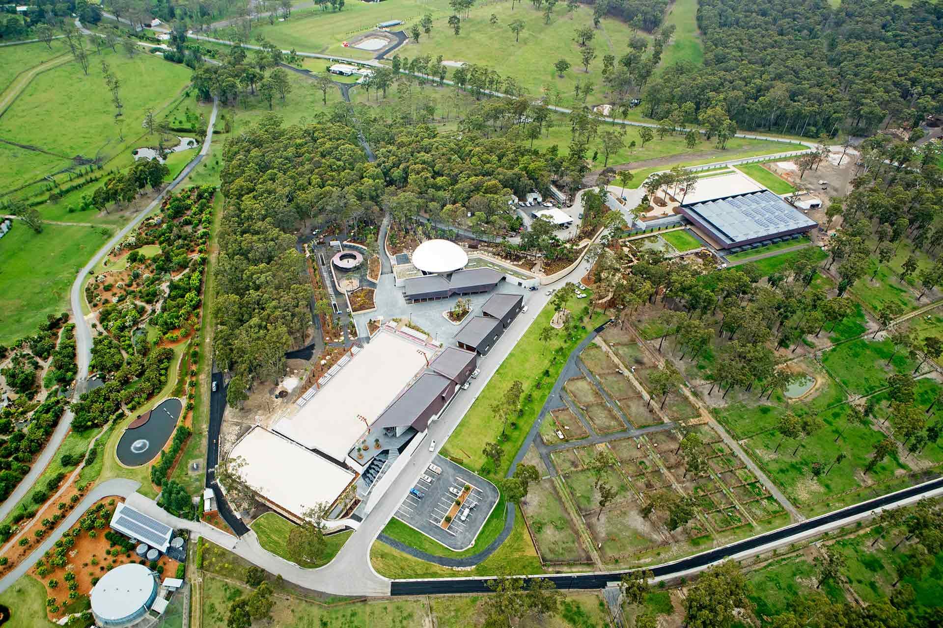An aerial view of a farm with lots of buildings and trees