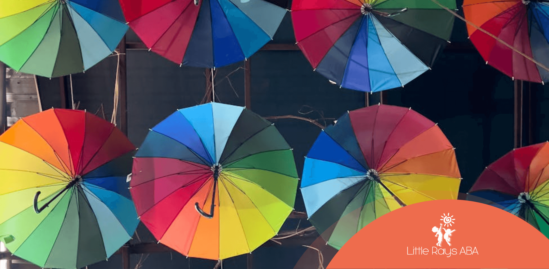 Colorful rainbow umbrellas hanging from a ceiling in Florida symbolizing the autism spectrum wheel.