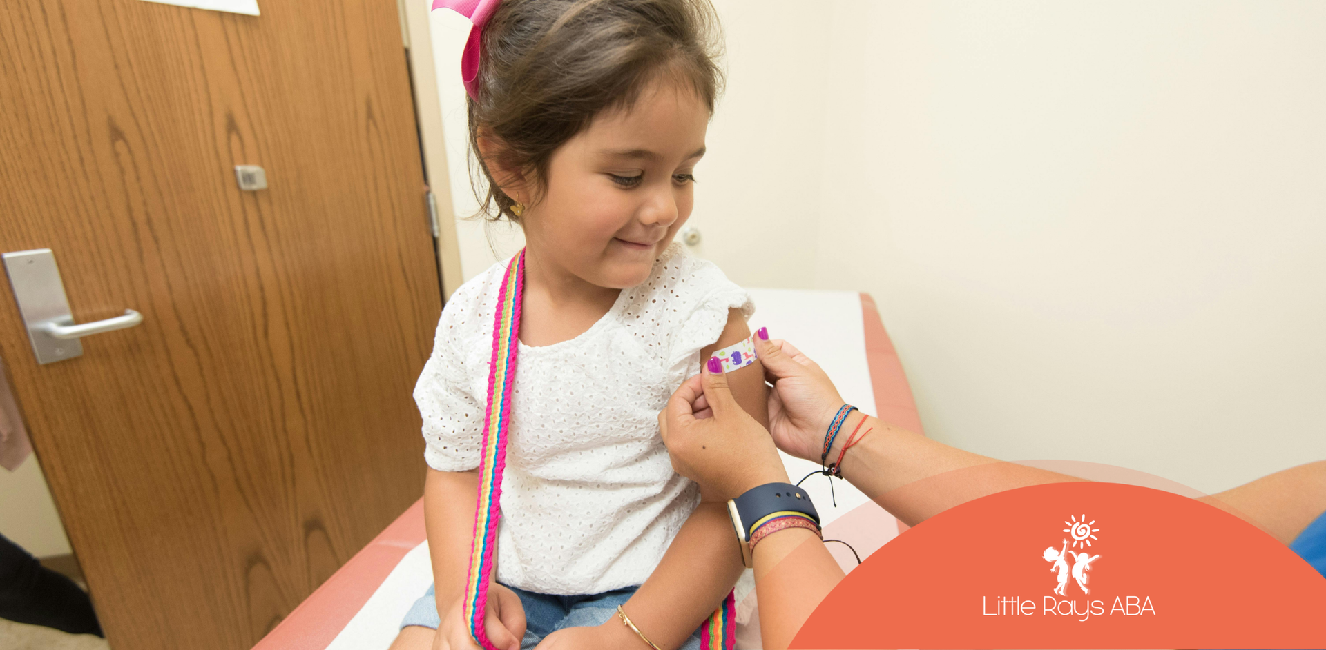 A little girl is being examined by a doctor.