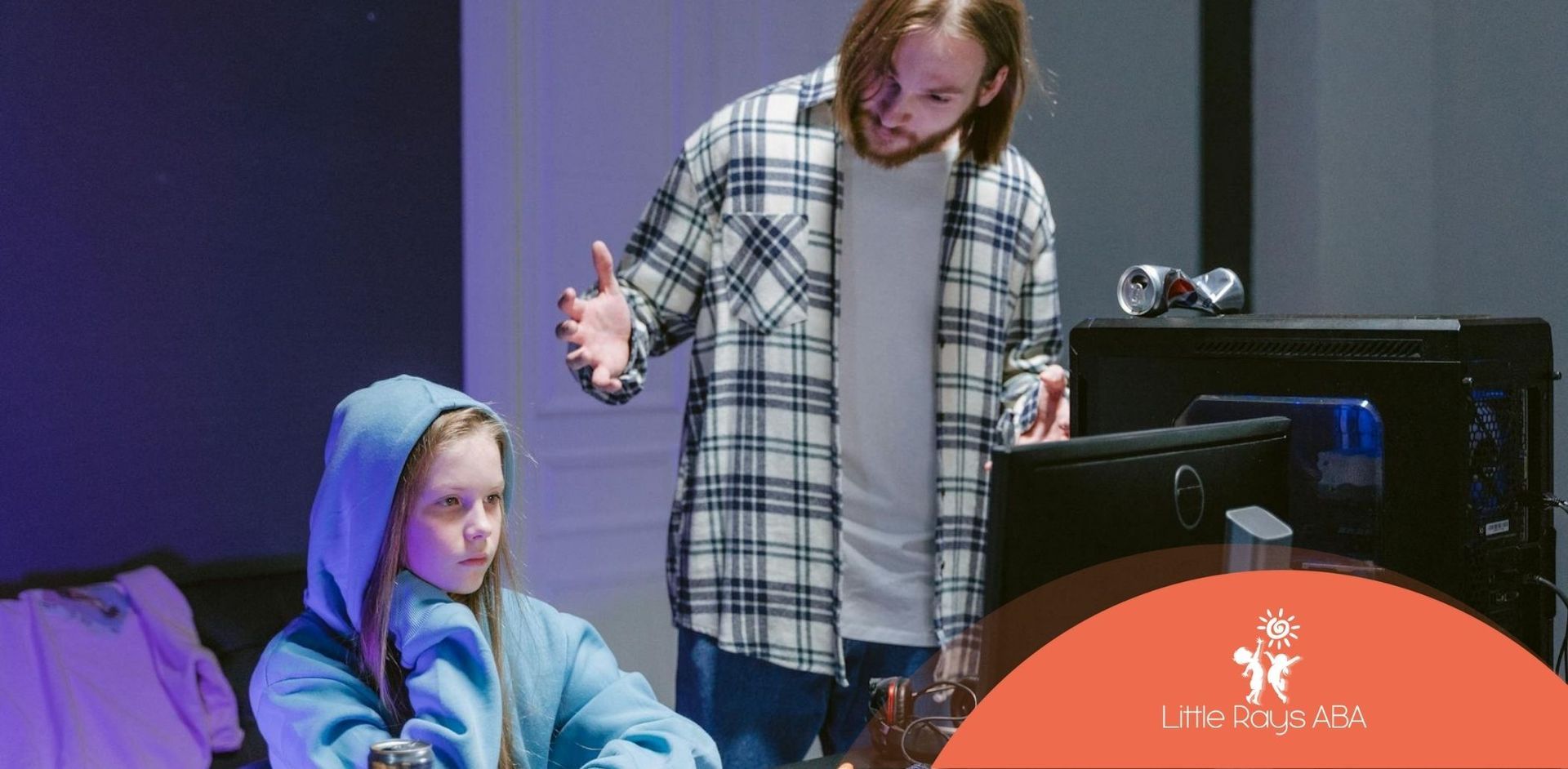 Autistic child sitting at a computer, while a parent stands behind, gesturing with frustration in FL