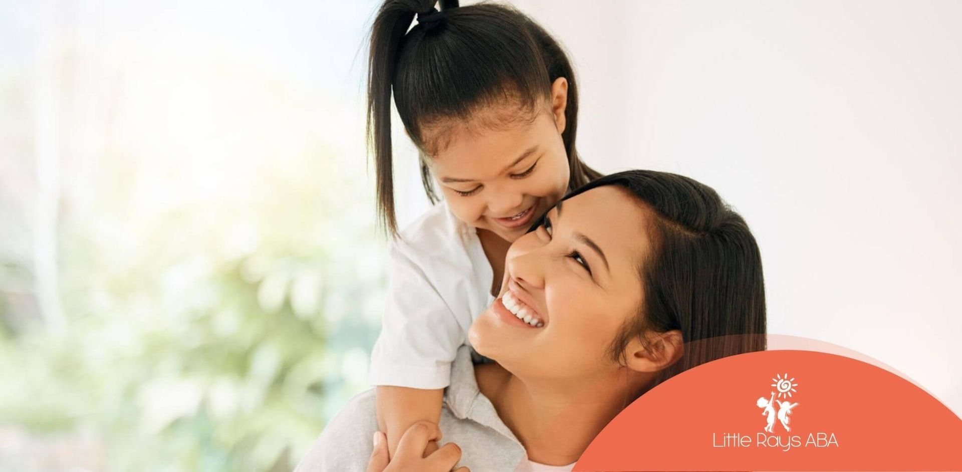 A BCBA is holding a little girl on her shoulders in ABA therapy.