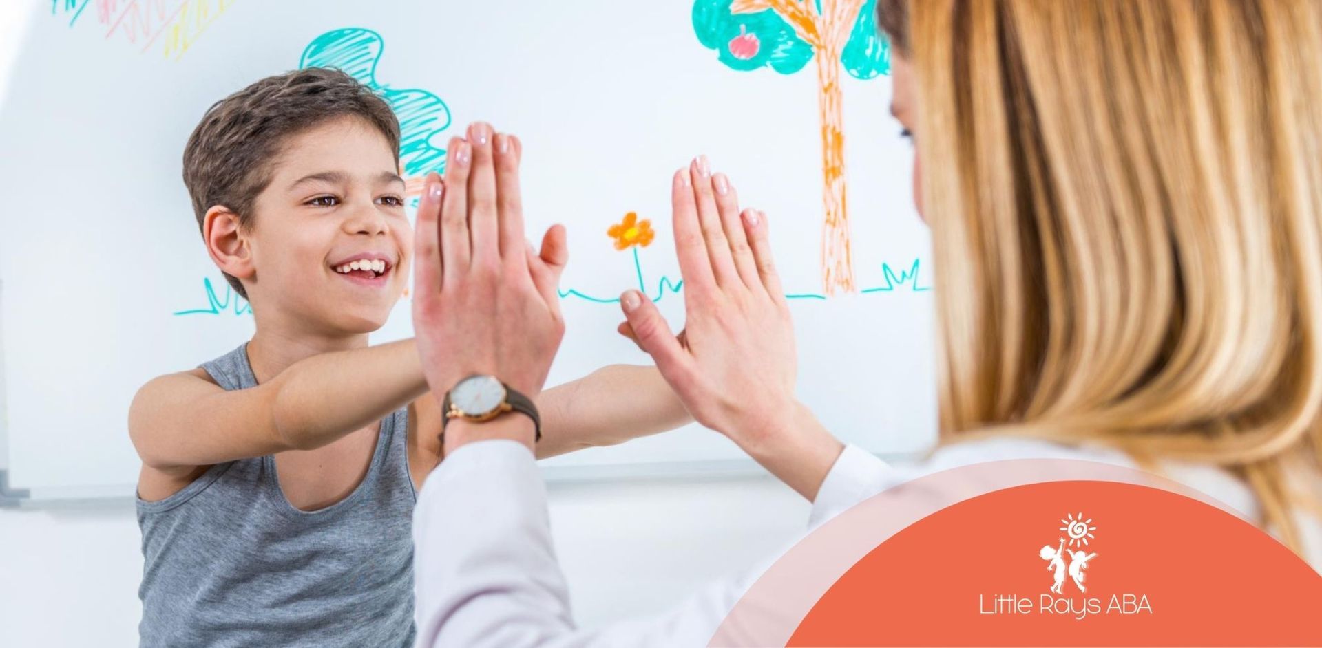 A young boy is giving a high five to a BCBA in Florida.