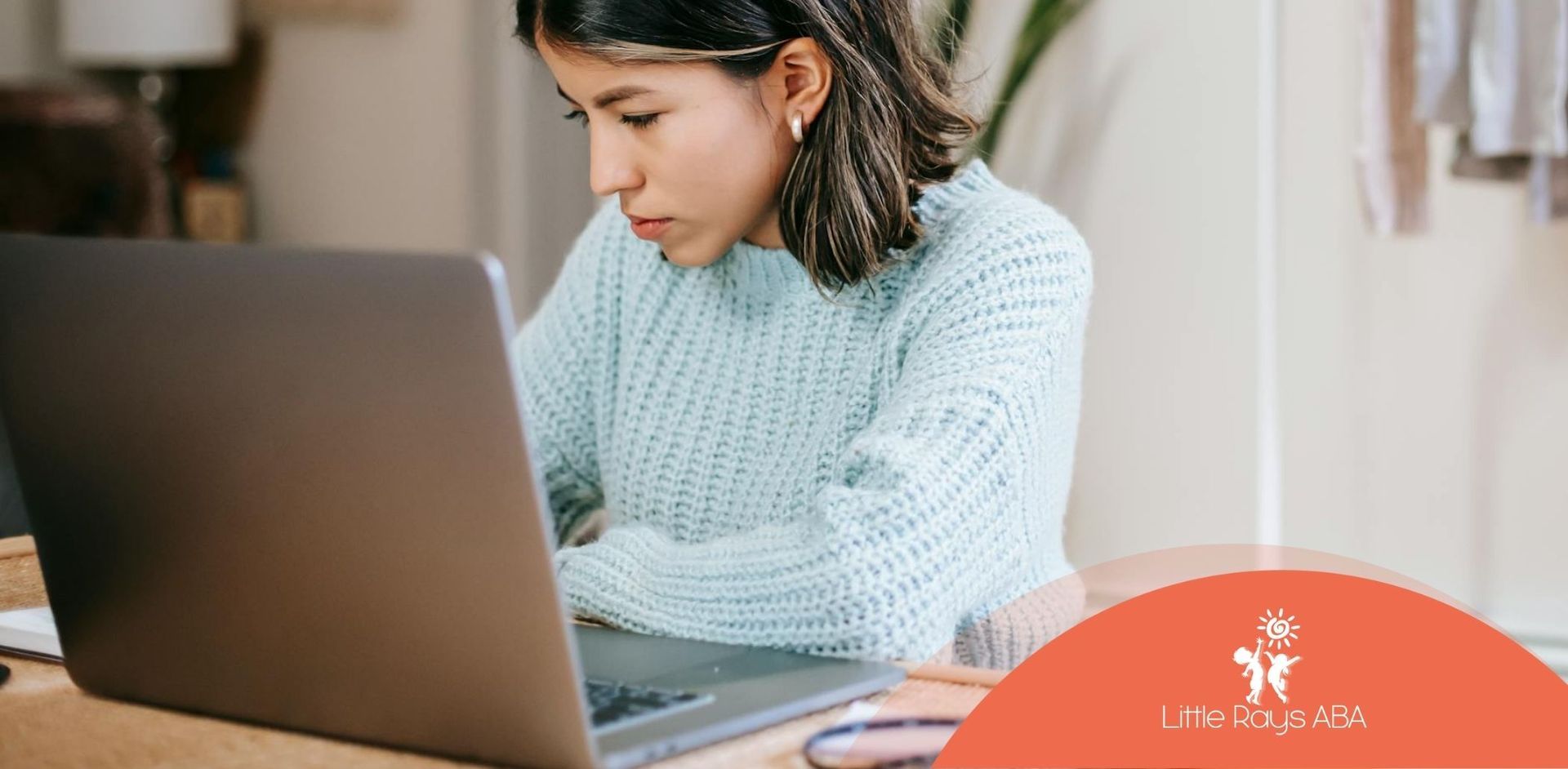 RBT student in a blue sweater concentrating during RBT exam study on her laptop at home in Florida.