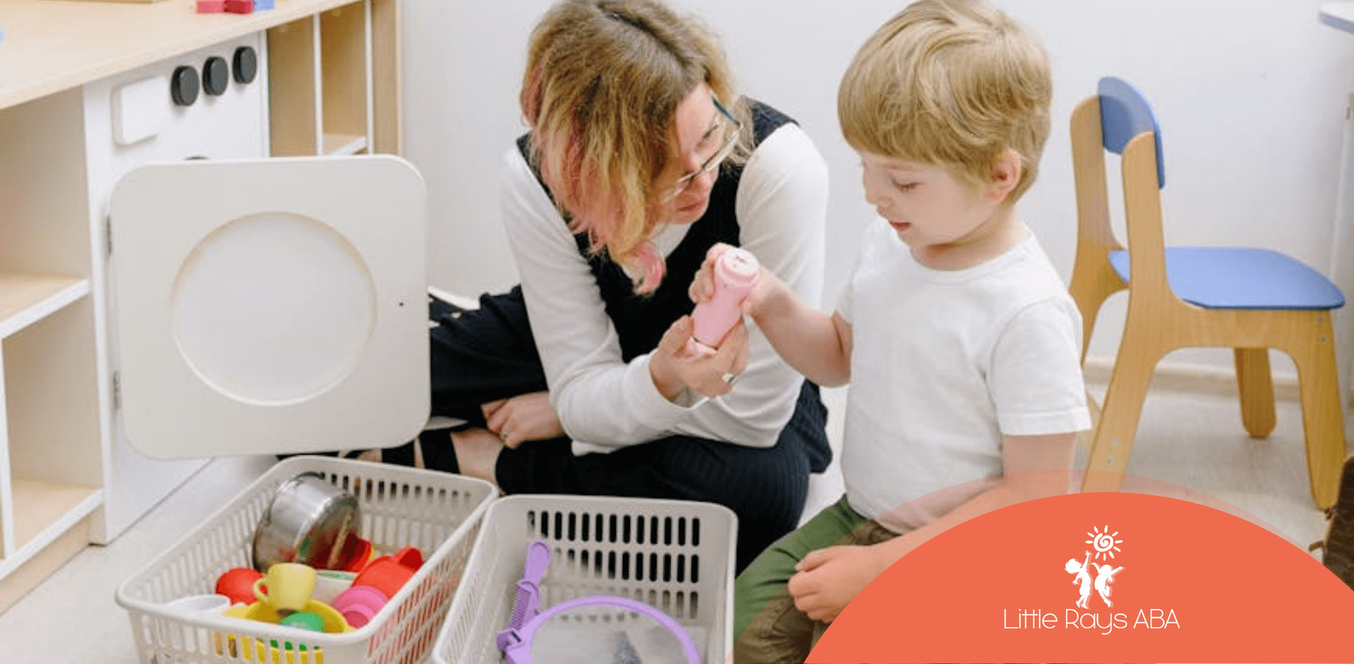 An ABA therapist and autistic child sorting plastic toys in a playroom during ABA therapy in FL.