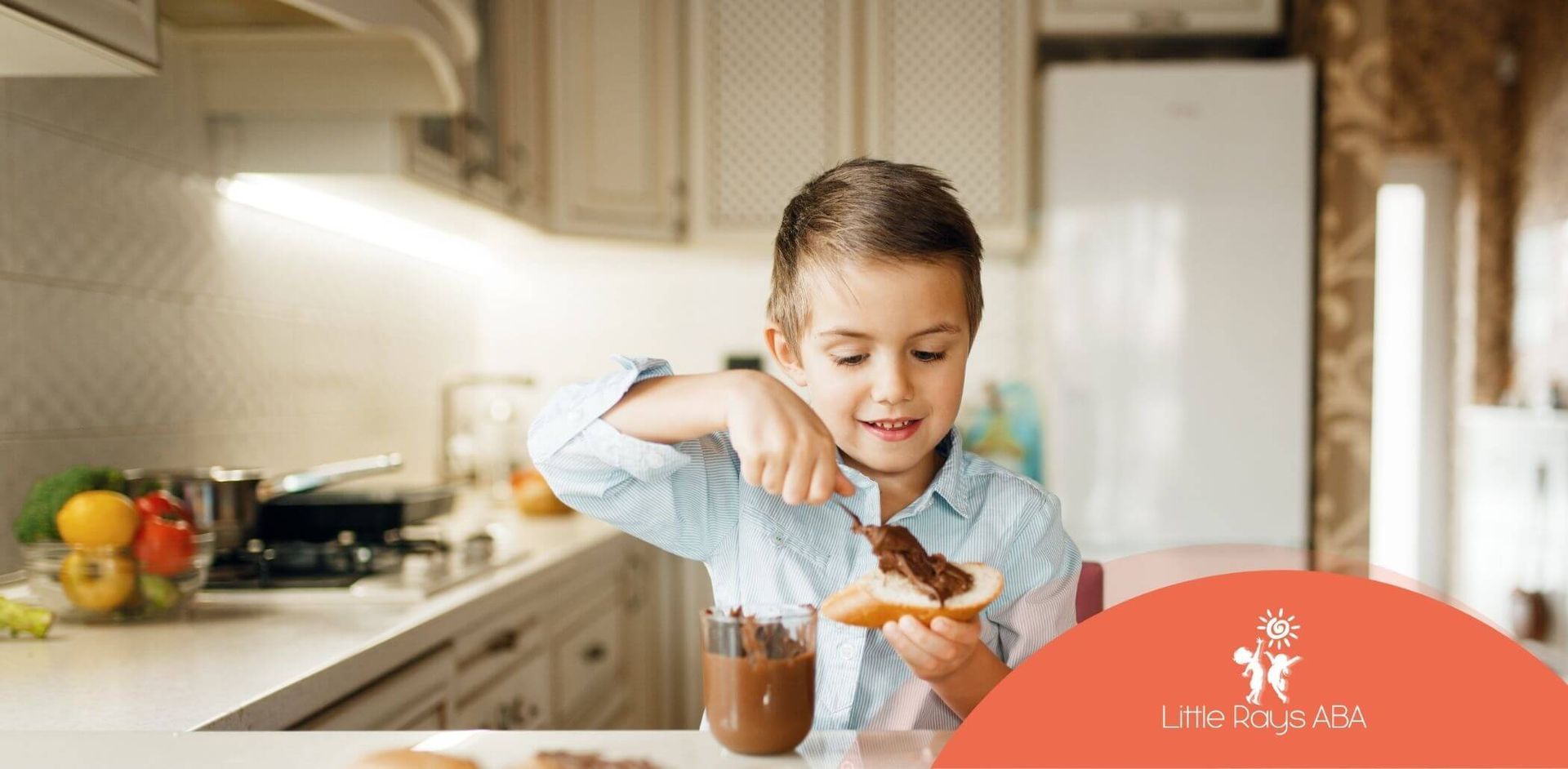 A young boy with autism is spreading chocolate spread on a piece of bread.