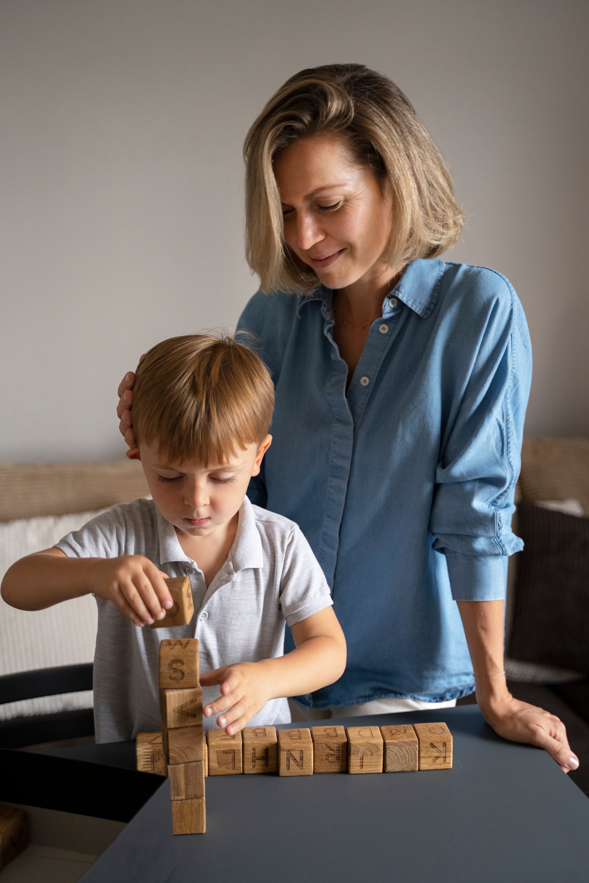 An RBT and a child are playing with blocks on the floor during an in-home aba therapy session