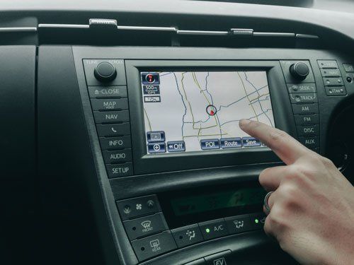 A Person Is Pointing At A Map On The Dashboard Of A Car - San Pablo, CA - Grand Prix Car Wash San Pablo