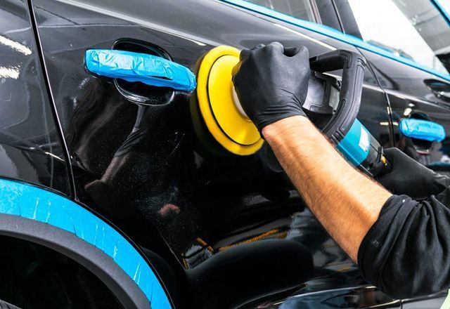 A Man Is Polishing A Black Car With A Polisher - San Pablo, CA - Grand Prix Car Wash San Pablo