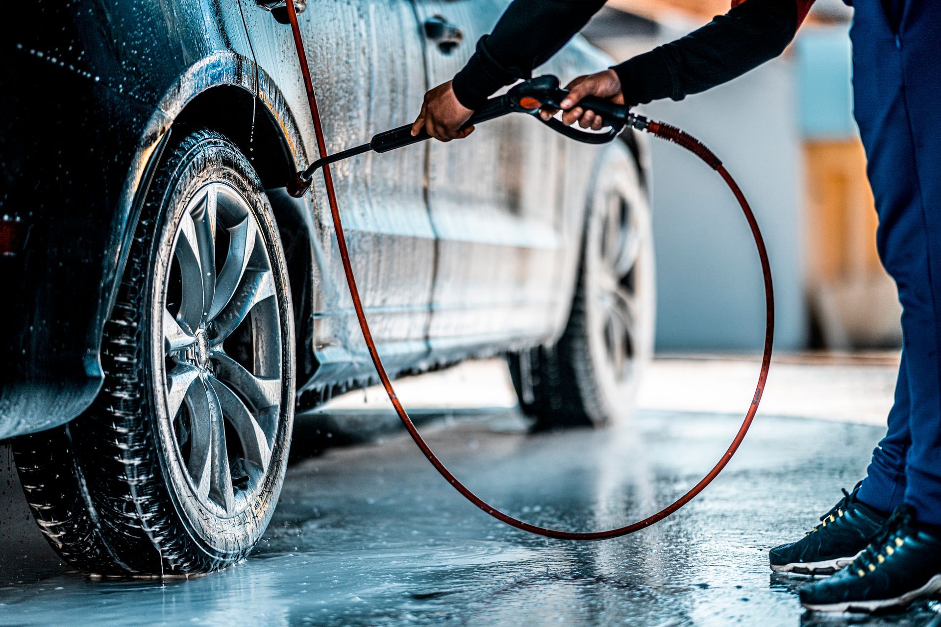 A Man Is Washing A Car With A High Pressure Washer - San Pablo, CA - Grand Prix Car Wash San Pablo
