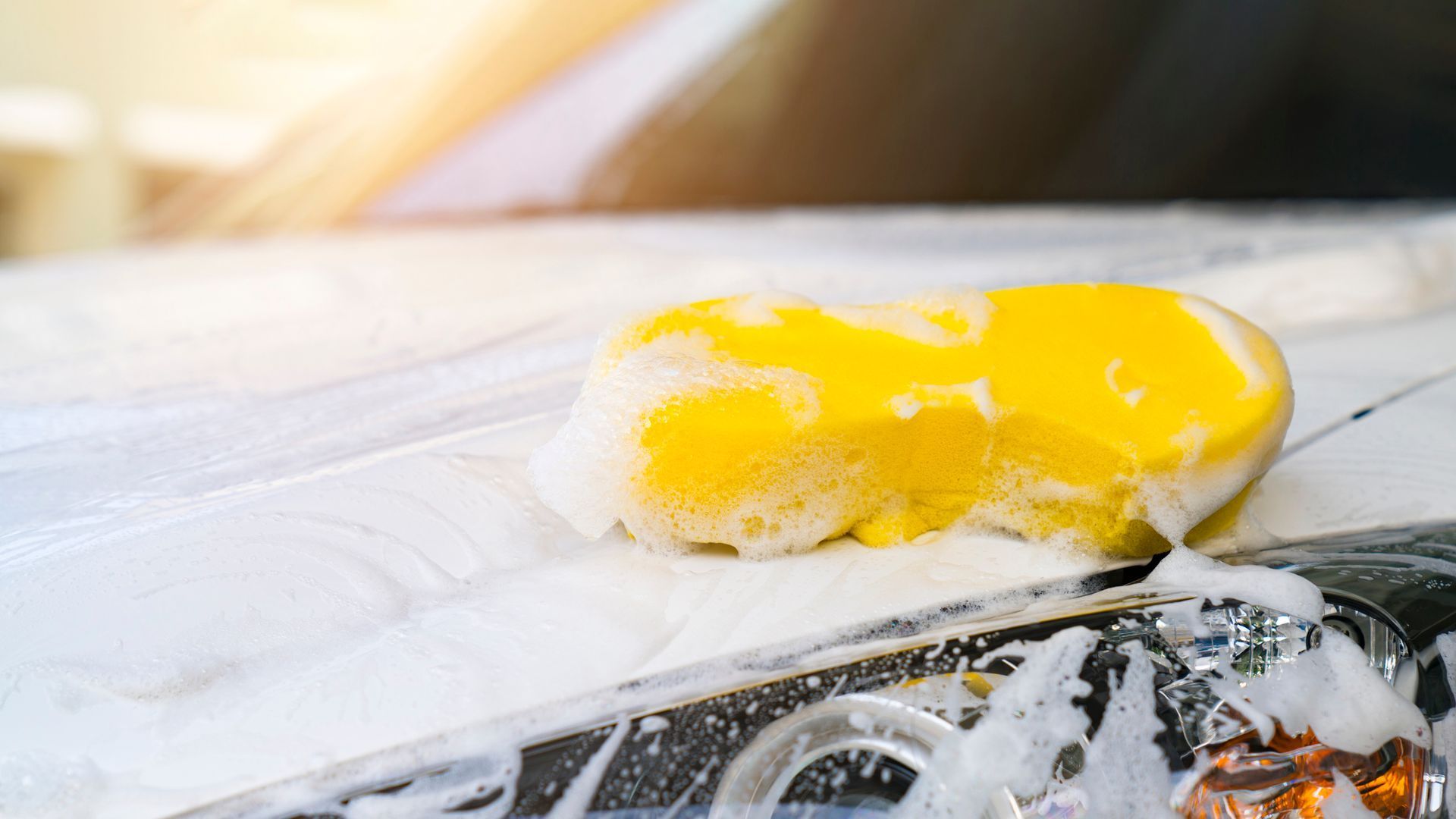 A Yellow Sponge Is Being Used To Wash A Car - San Pablo, CA - Grand Prix Car Wash San Pablo