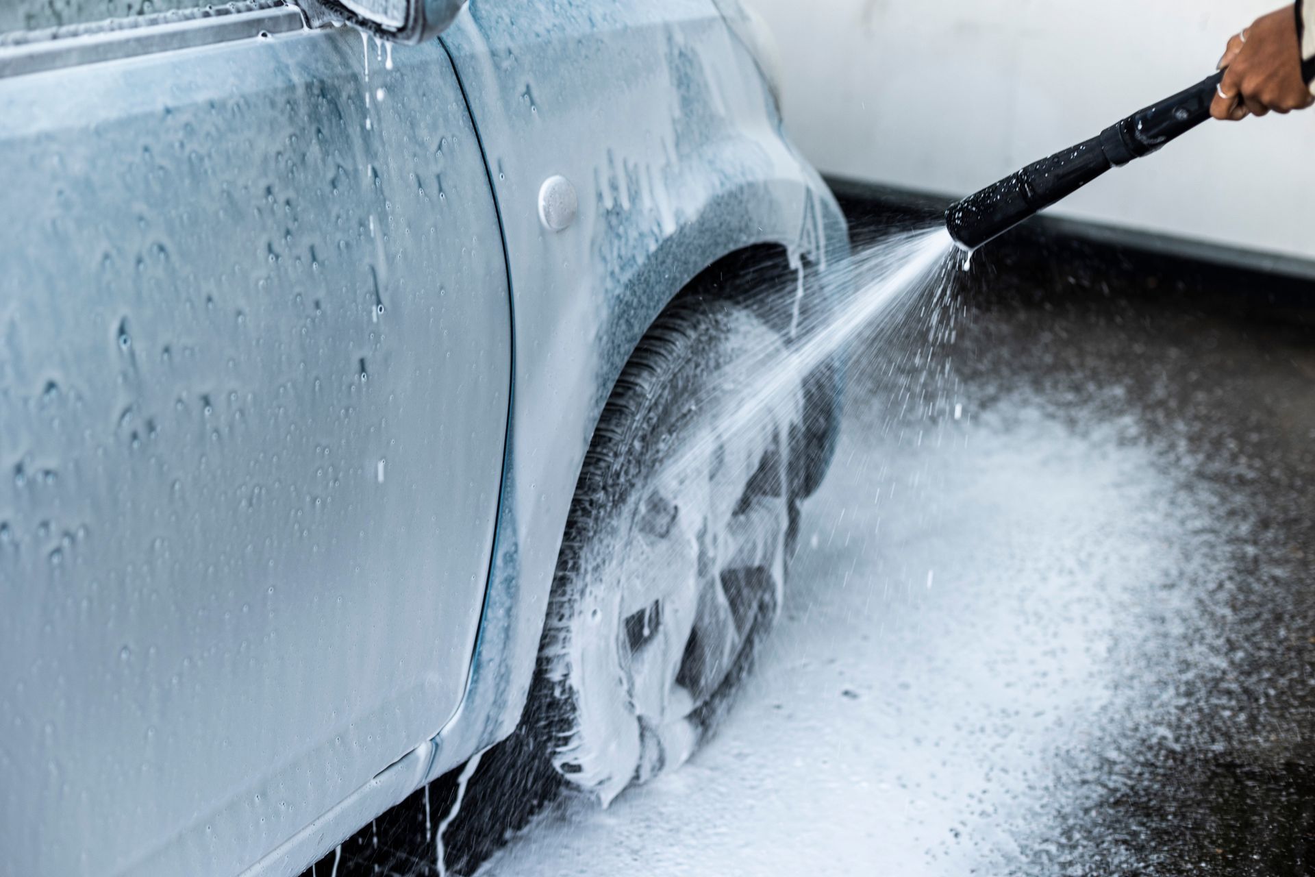 A Person Is Washing A Car With A High Pressure Washer - San Pablo, CA - Grand Prix Car Wash San Pablo